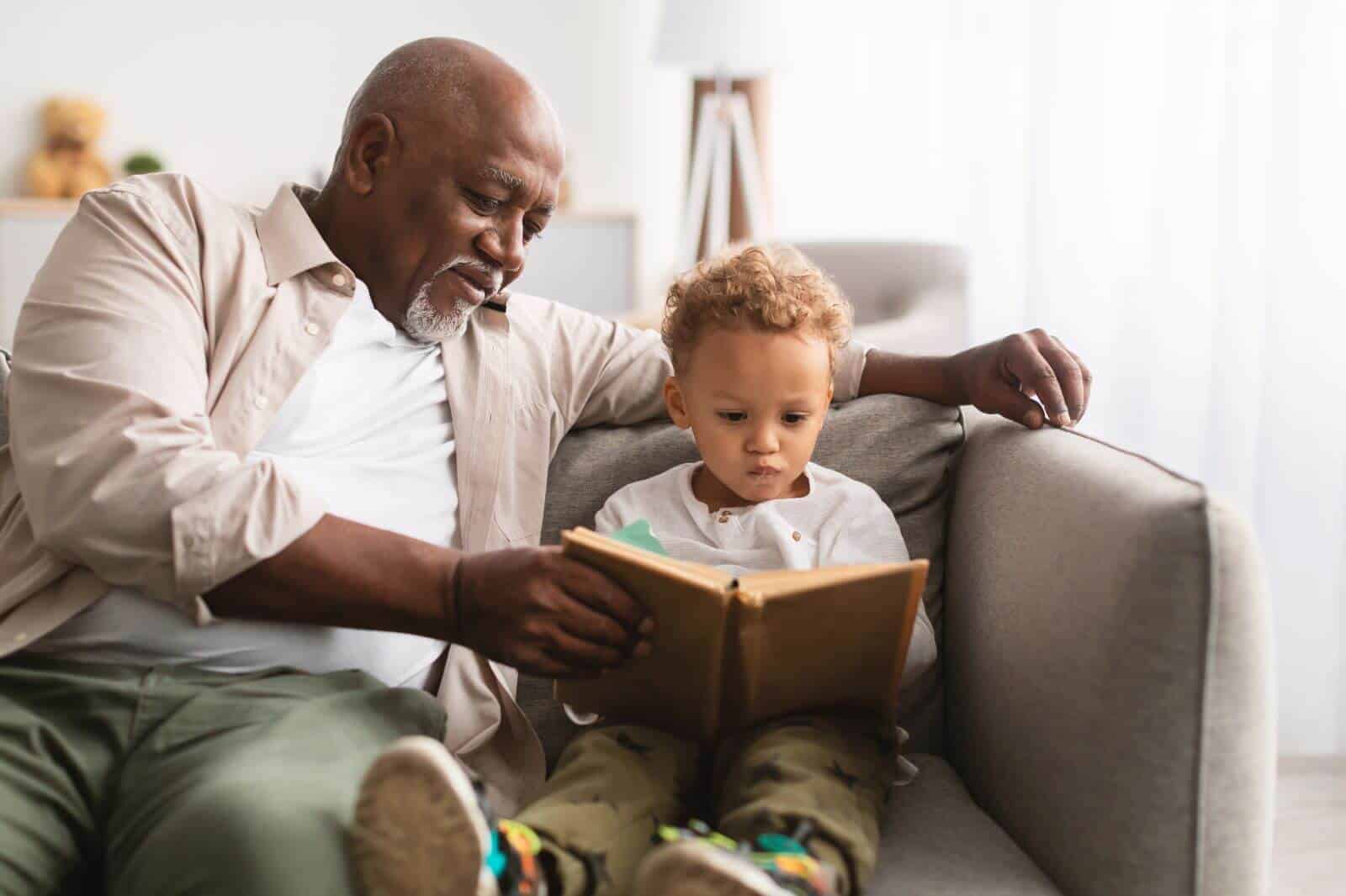 grandpa reading a book with his grandchild