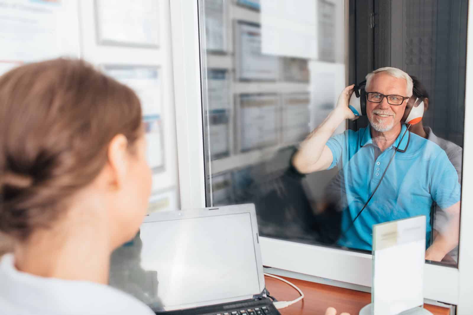 audiologist conducting hearing test